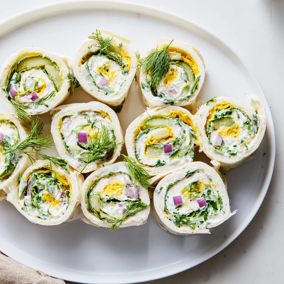 Vibrant Pickle-in-a-Blanket spirals, perfect for snacking or party appetizers.
