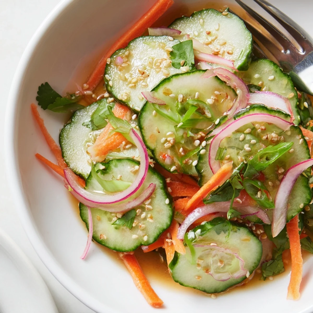 Vibrant cucumber salad remix tossed in sesame oil and fish sauce dressing.  