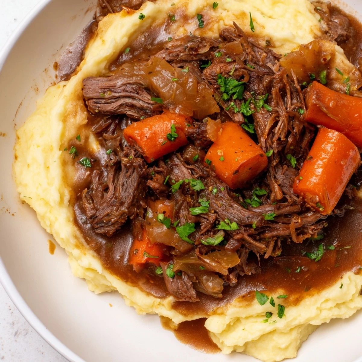 Tender slow cooker pot roast with carrots and potatoes, a hearty family-style dinner.