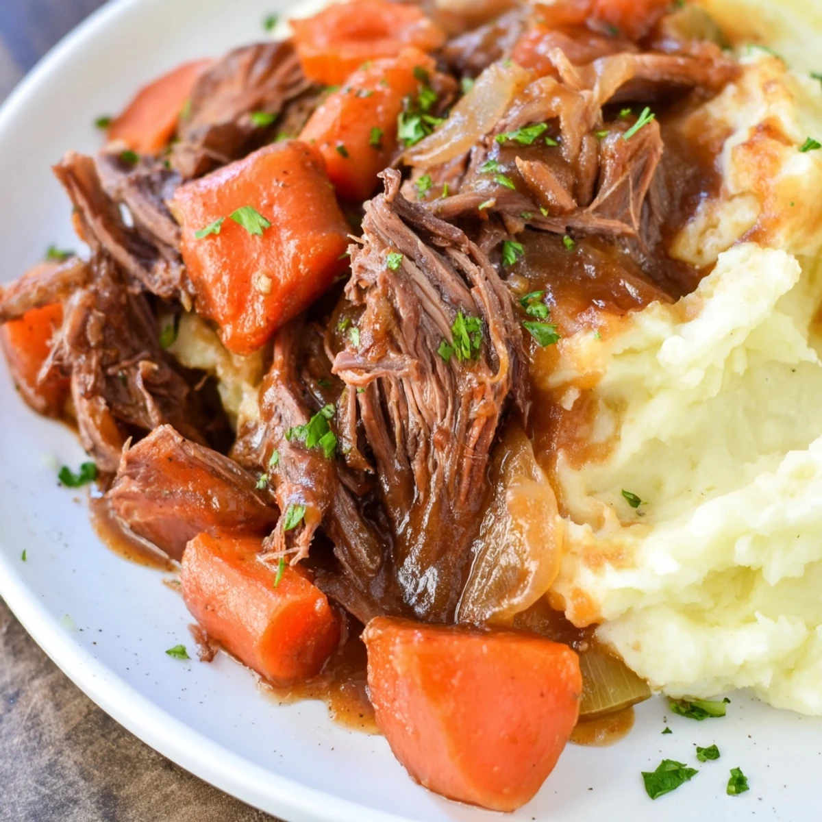 Fork-tender pot roast, served with creamy mashed potatoes, the ultimate comfort food meal.