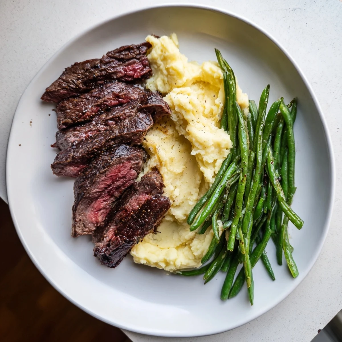 Sheet pan showcasing steak and garlic mash, a flavorful American one-pan meal.