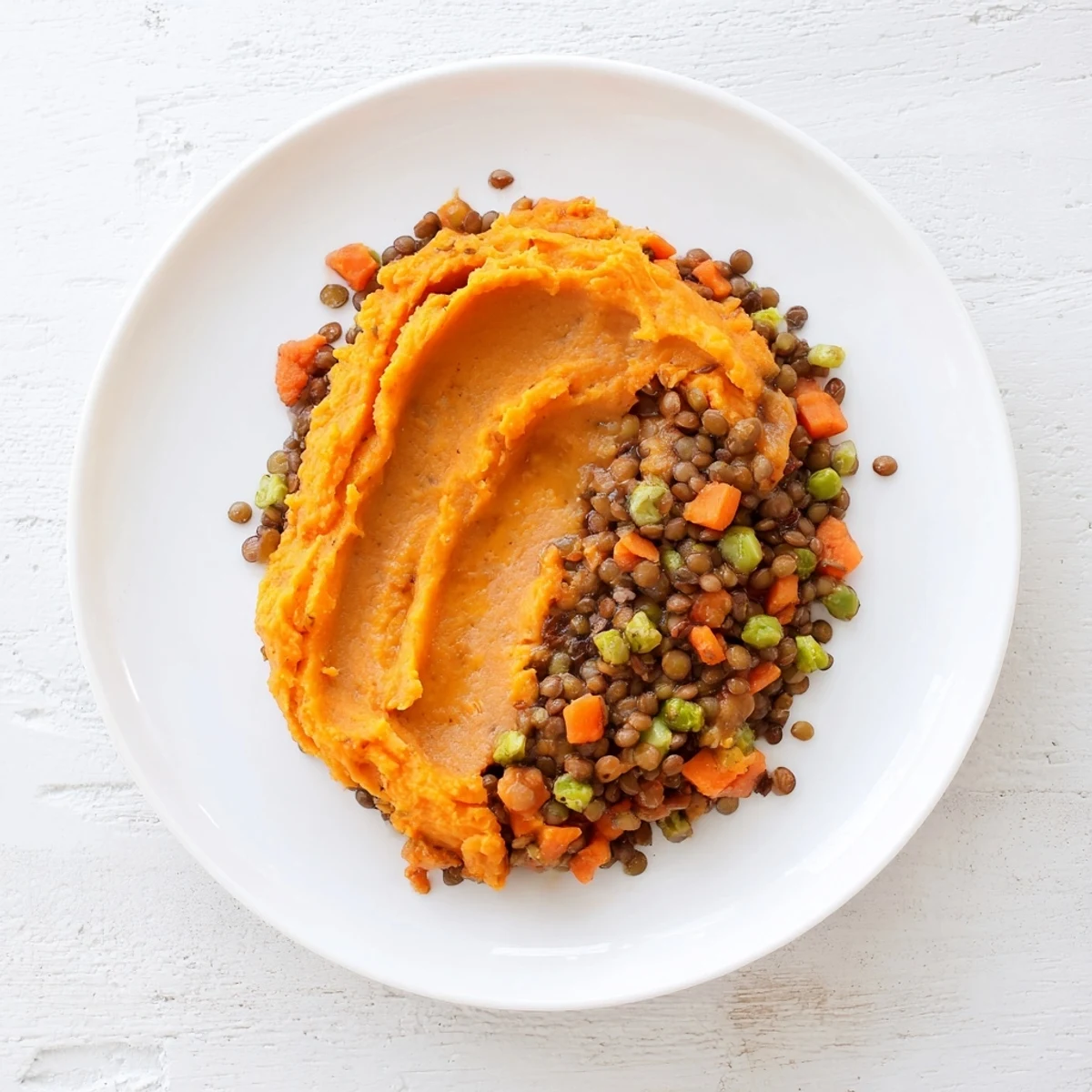 A close-up of a hearty Veggie Shepherd's Pie, perfectly showcasing the sweet potato topping's texture.