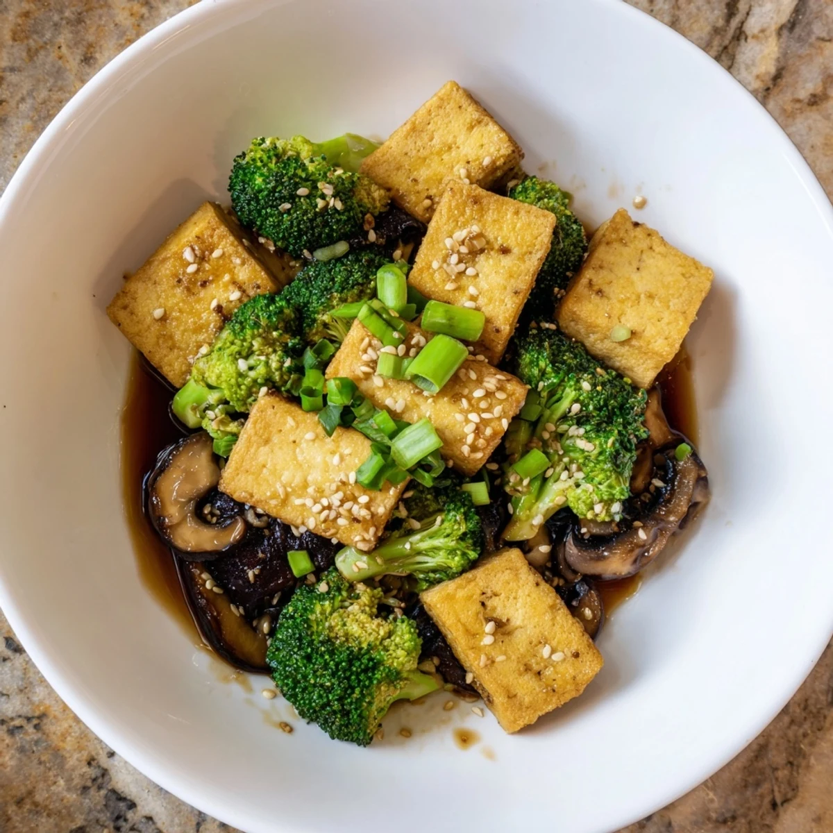 Golden-brown Sautéed Tofu Steak with Broccoli, a vegan dish with vibrant vegetables and a rich sauce.