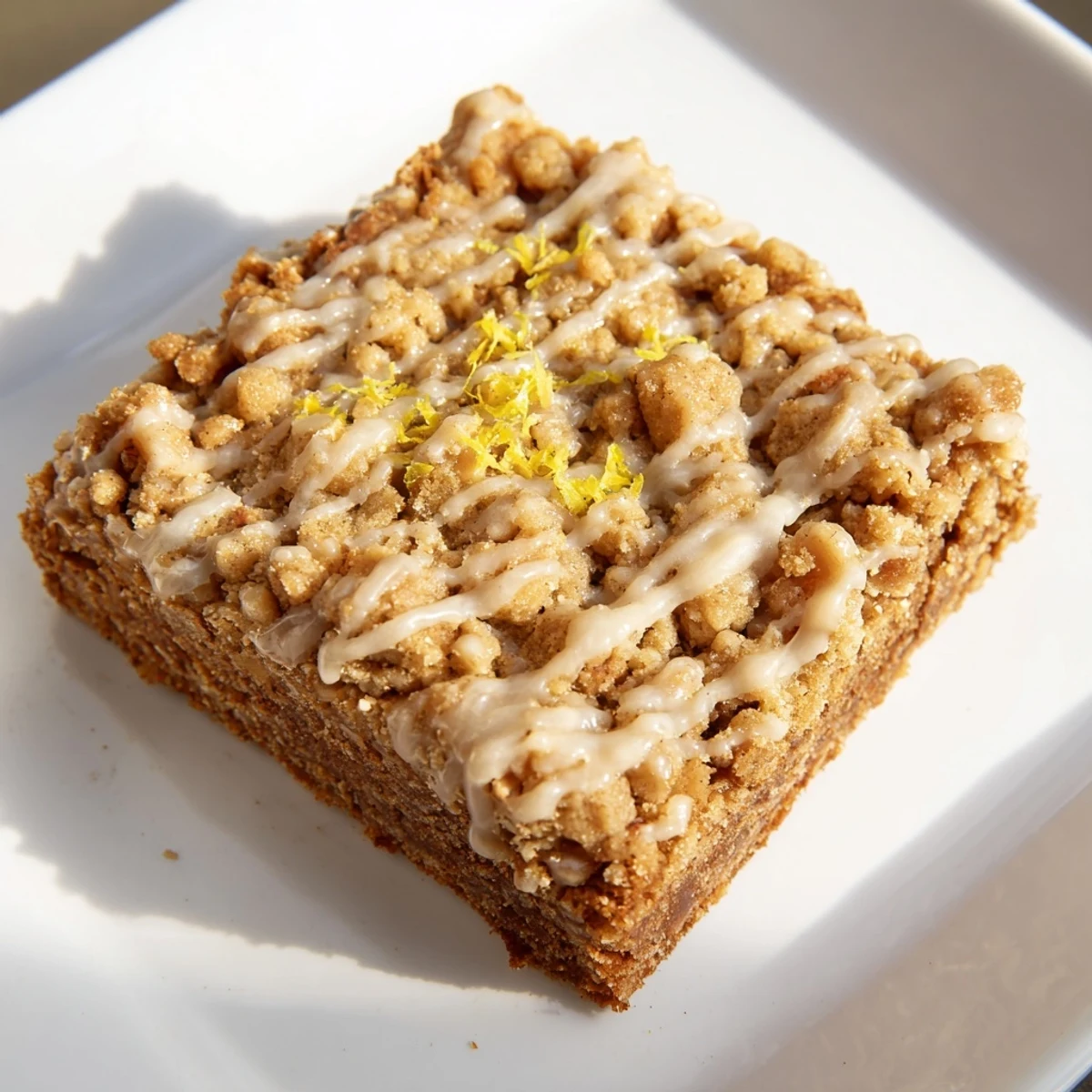 Cozy scene: freshly baked Lemon-Glazed Gingerbread Crumble Bars offering a delightful, seasonal treat.