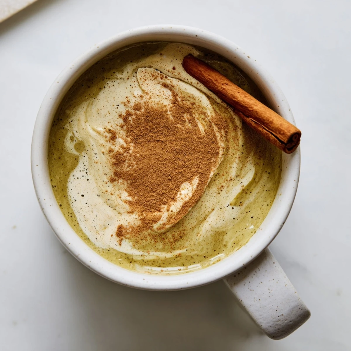 Rich green and creamy Maple Cinnamon Gingerbread Matcha Oat Latte, a delicious vegan treat.
