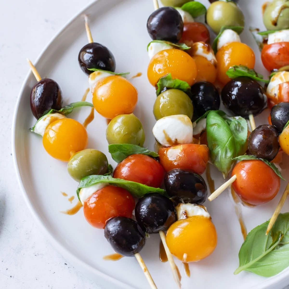 Christmas Lights Olive and Tomato Skewers arranged on a platter, showcasing vibrant cherry tomatoes and green olives.