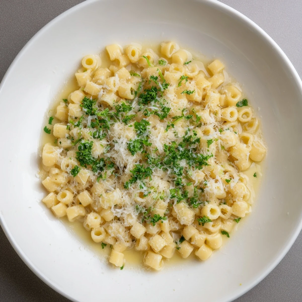 Golden garlic-infused butter coats the ditalini pasta, a simple one-pot meal, ready to eat.