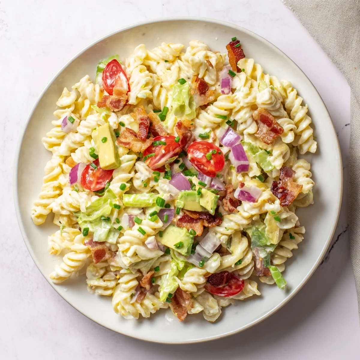 This stunning BLT Pasta Salad features perfectly cooked pasta, flavorful bacon, and fresh, vibrant vegetables.