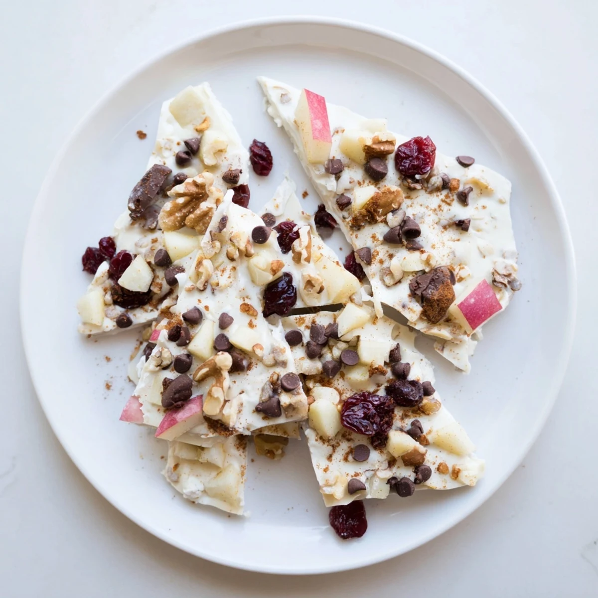 Enjoy a refreshing bite of this delicious Apple Cinnamon Yogurt Bark, perfect for a healthy snack.