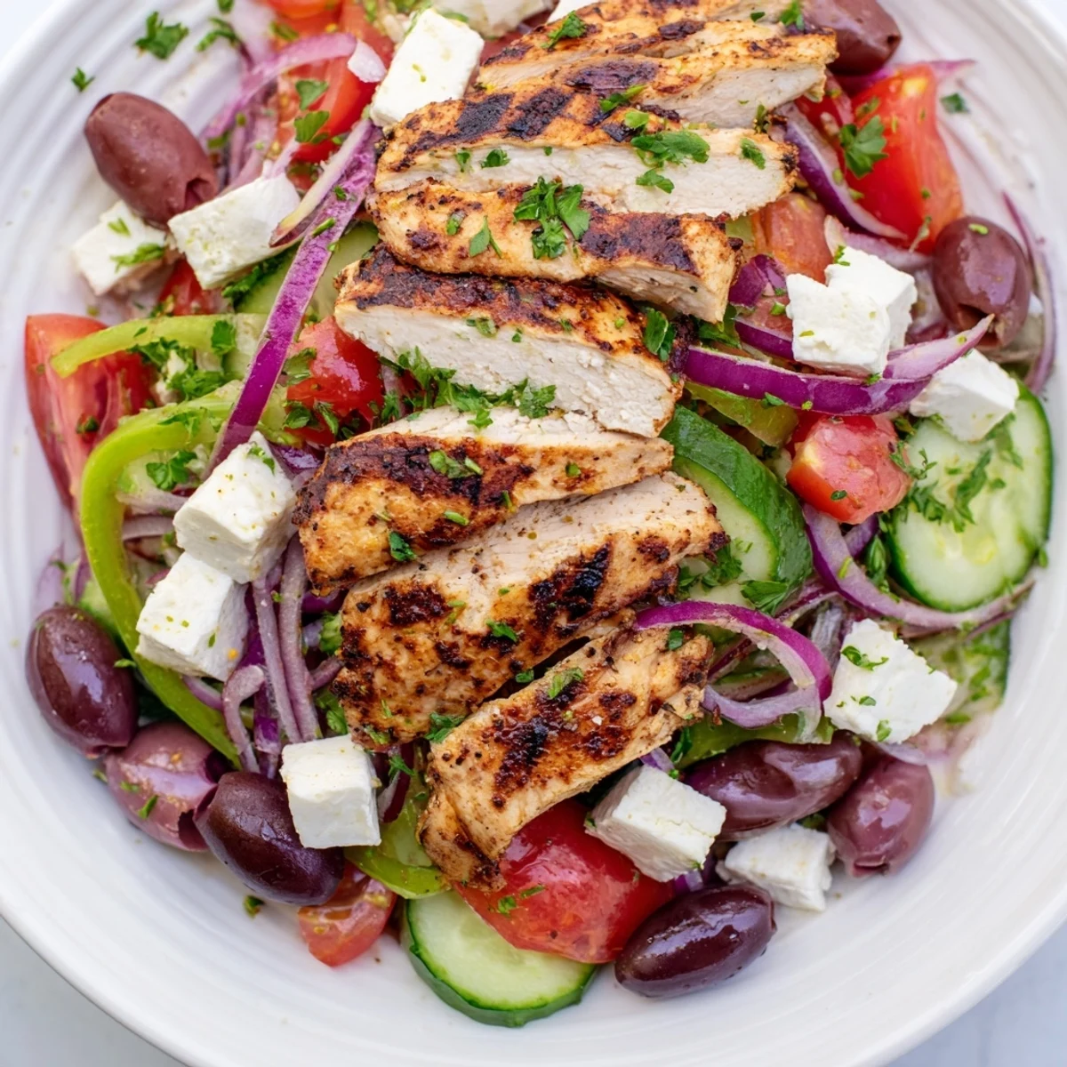 Delicious Greek salad with grilled chicken: a healthy, flavorful mix of textures and bright flavors.