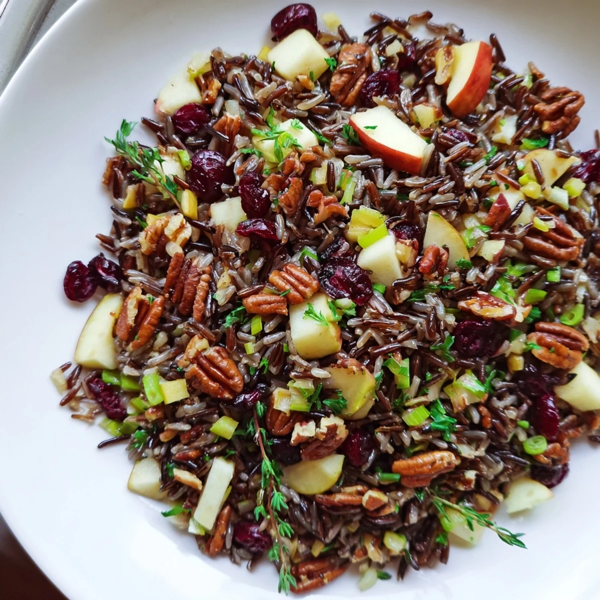 Tender wild rice harvest salad, tossed with vibrant herbs and a tangy vinaigrette, perfect for autumn.