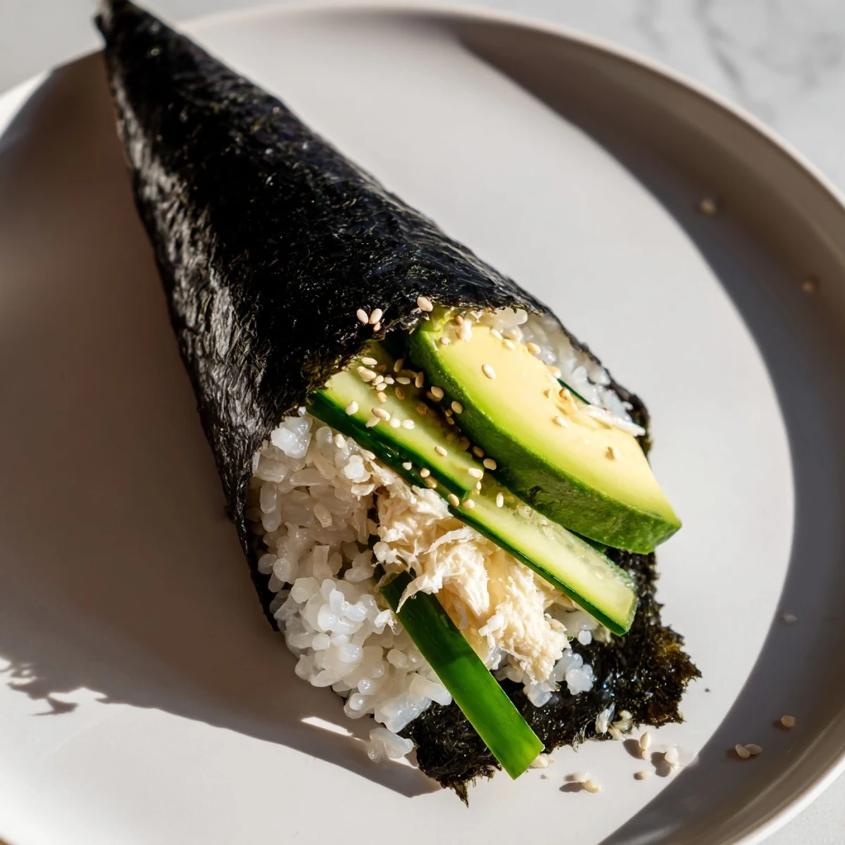 Freshly made Sushi Rice Hand Rolls with creamy avocado, ready to enjoy with soy sauce.