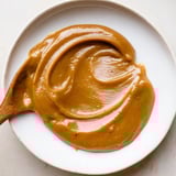 A close-up of Emirati Al Madrooba: a thick, sweet date paste swirled in a pan.