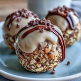 No-bake peanut butter oat bites with chocolate chips on a white plate.