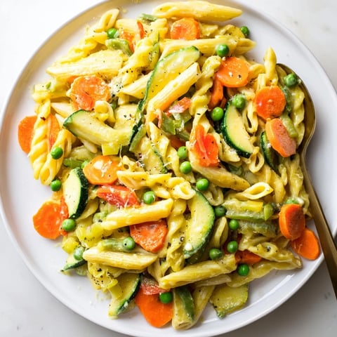A colorful One-Pot Pasta Primavera with fresh vegetables and creamy sauce.  