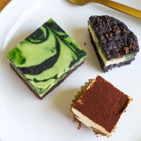 Delicious matcha-miso brownies topped with a fudgy chocolate glaze, perfect for dessert.  