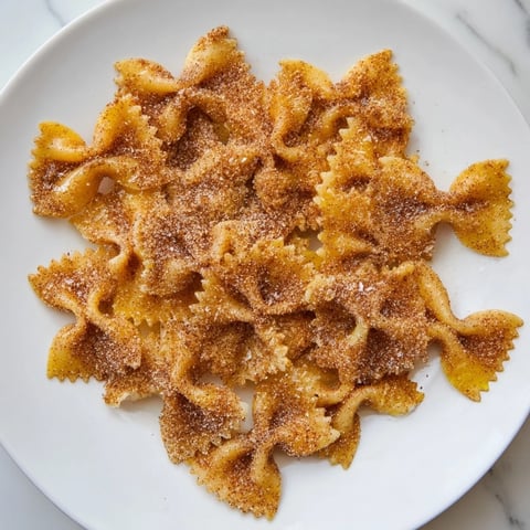 Golden, crunchy Air Fryer Pasta Christmas Crack, perfectly coated in sweet cinnamon sugar and ready to eat.