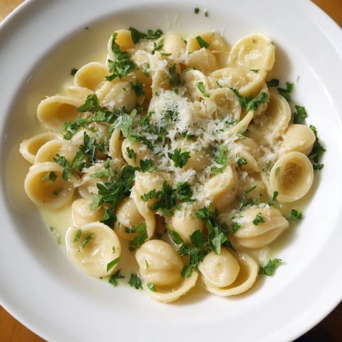 One-Pot Garlic Butter Ditalini, a creamy delight, is garnished with fresh parsley and Parmesan.