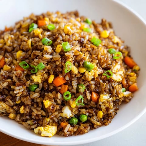 Fluffy Black Garlic Fried Rice with vibrant green scallions, perfect for a quick, yummy weeknight meal.