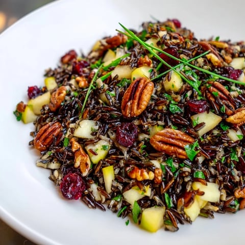 A colorful wild rice harvest salad, dotted with cranberries and toasted pecans, ready to serve.