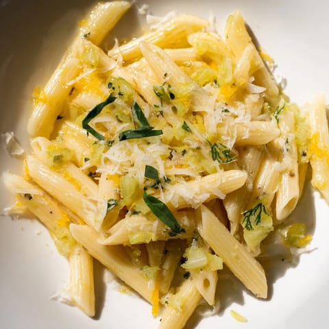 Tangy Lemon Basil Pickle Pasta, plated beautifully with fresh basil garnish and parmesan.