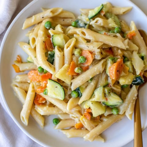 Delicious One-Pot Pasta Primavera, vibrant veggies mingling in a savory broth.  