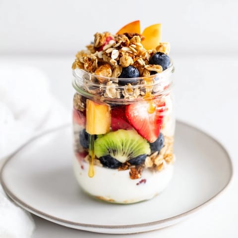 Vibrant image of a yogurt parfait made with fresh fruit and granola, perfect for a quick snack.