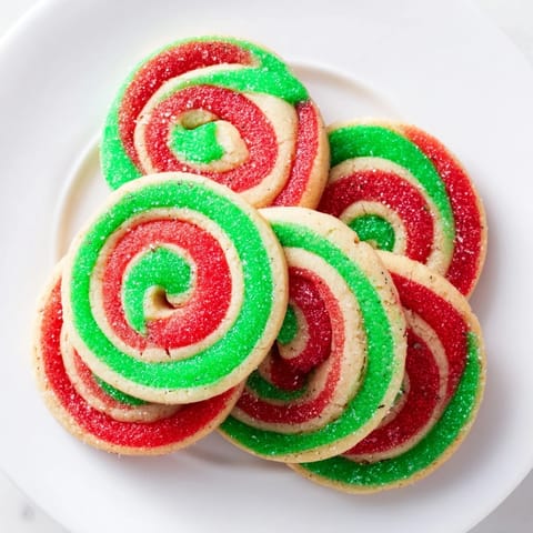 Festive Holiday Pinwheel Cookies, showcasing vibrant red and green spirals fresh from the oven, ready to share.