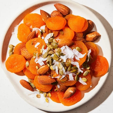 Simple fruit & nut pile: A beautiful arrangement of sweet dried apricots and crunchy almonds ready to enjoy.