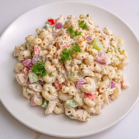 Creamy, Southern-style Chicken Macaroni Holiday Salad, ready to serve cold at a potluck gathering.