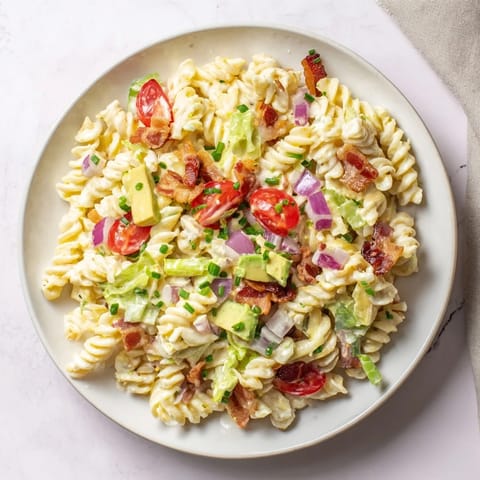 This stunning BLT Pasta Salad features perfectly cooked pasta, flavorful bacon, and fresh, vibrant vegetables.