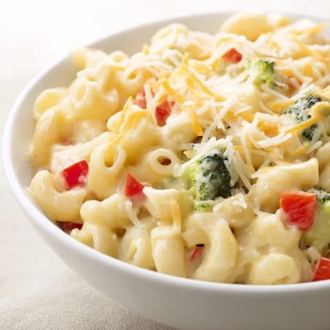 This hearty Roasted Veggie Mac & Cheese features a golden, baked top with colorful vegetables in every satisfying forkful.  