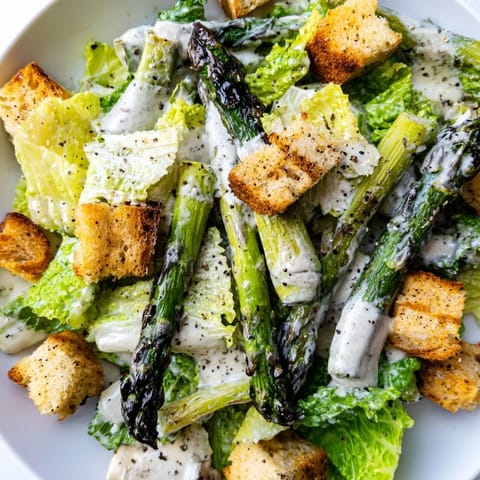 Shaved Parmesan cheese and a drizzle of creamy dressing finish this fresh Roasted Asparagus Caesar Salad.