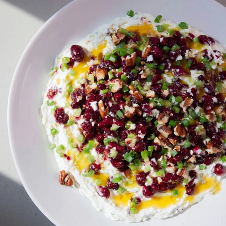 Creamy cream cheese base topped with tangy cranberry jalapeño dip and honey.  