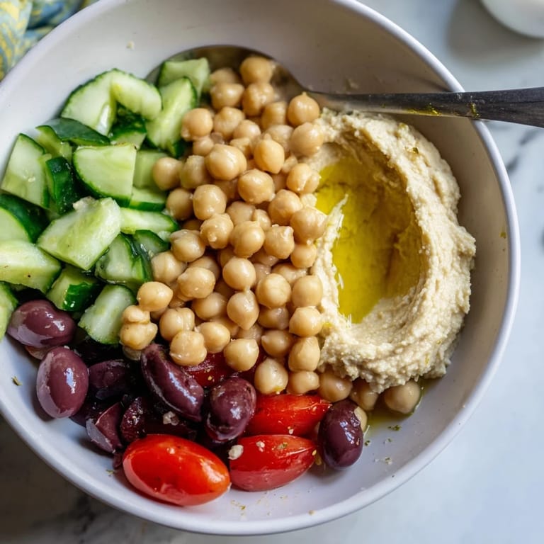 Savory Mediterranean Chickpea Bowl topped with rich hummus, perfect for a quick lunch.