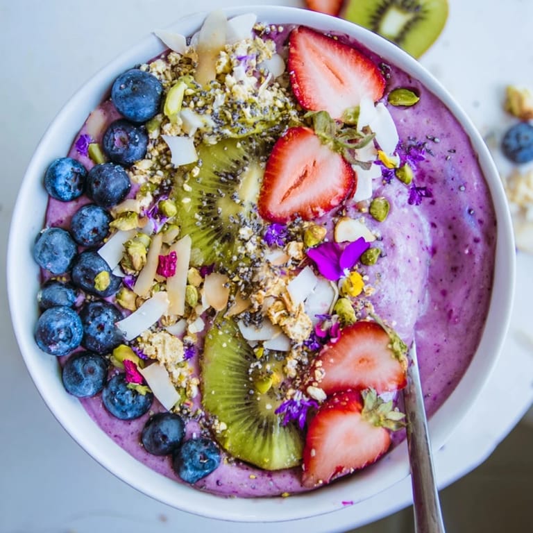Delicious smoothie bowl bursting with color, featuring banana and crunchy toppings.  