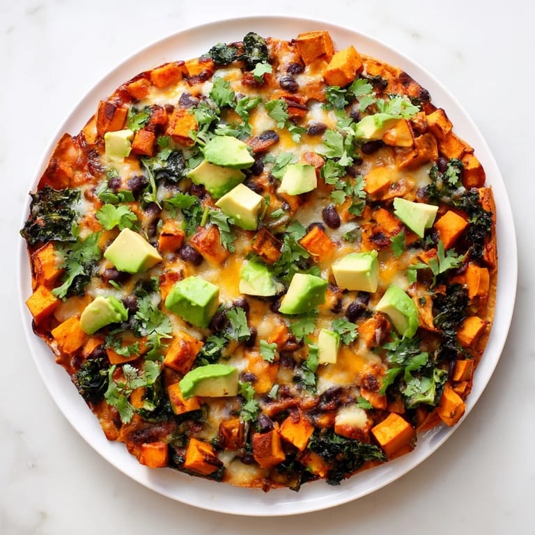Envision cheesy One-Pan Sweet Potato, Black Bean & Kale Enchiladas, with earthy sweet potatoes and heartwarming spices.