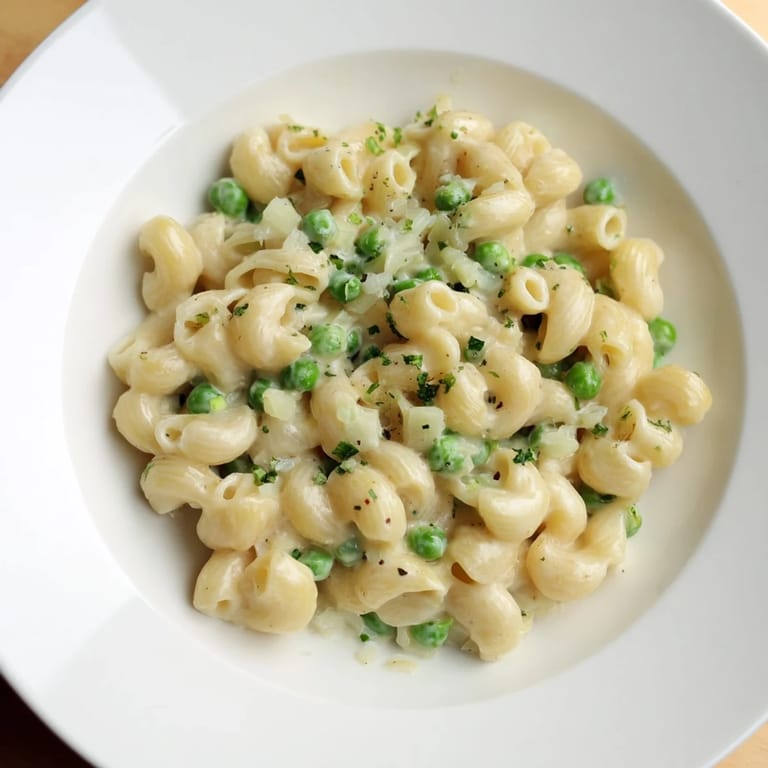Savory Macaroni & Peas in a skillet, the vegetarian comfort food with a light, flavorful sauce.
