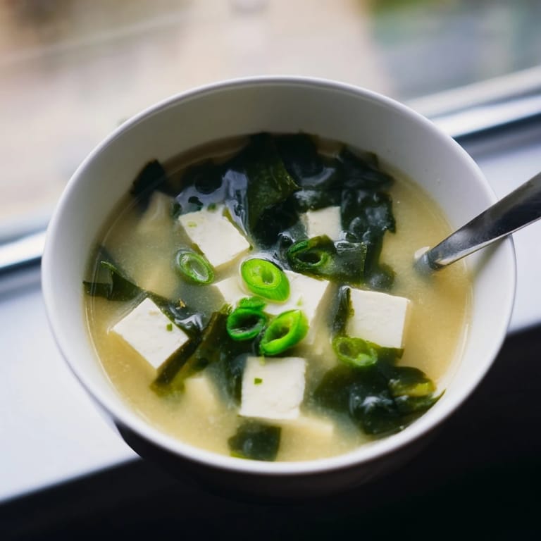 This Miso Soup With Tofu is garnished with fresh scallions, offering a comforting, healthy starter ready in just twenty minutes.