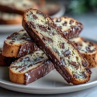 Golden biscotti with candied orange peel and dark chocolate chunks, perfect for coffee or dessert wine pairing.  