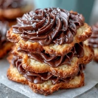 Beautiful flower-shaped shortbread cookies with golden edges, dusted with powdered sugar for a delicate finish.