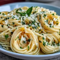 A bowl of Spring Pasta Limone with silky lemon-butter sauce, parmesan, and fresh basil—bright and zesty for springtime dining.