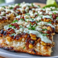 Cinco de Mayo Street Corn Flatbread, charred corn, cotija, and jalapeño crema.